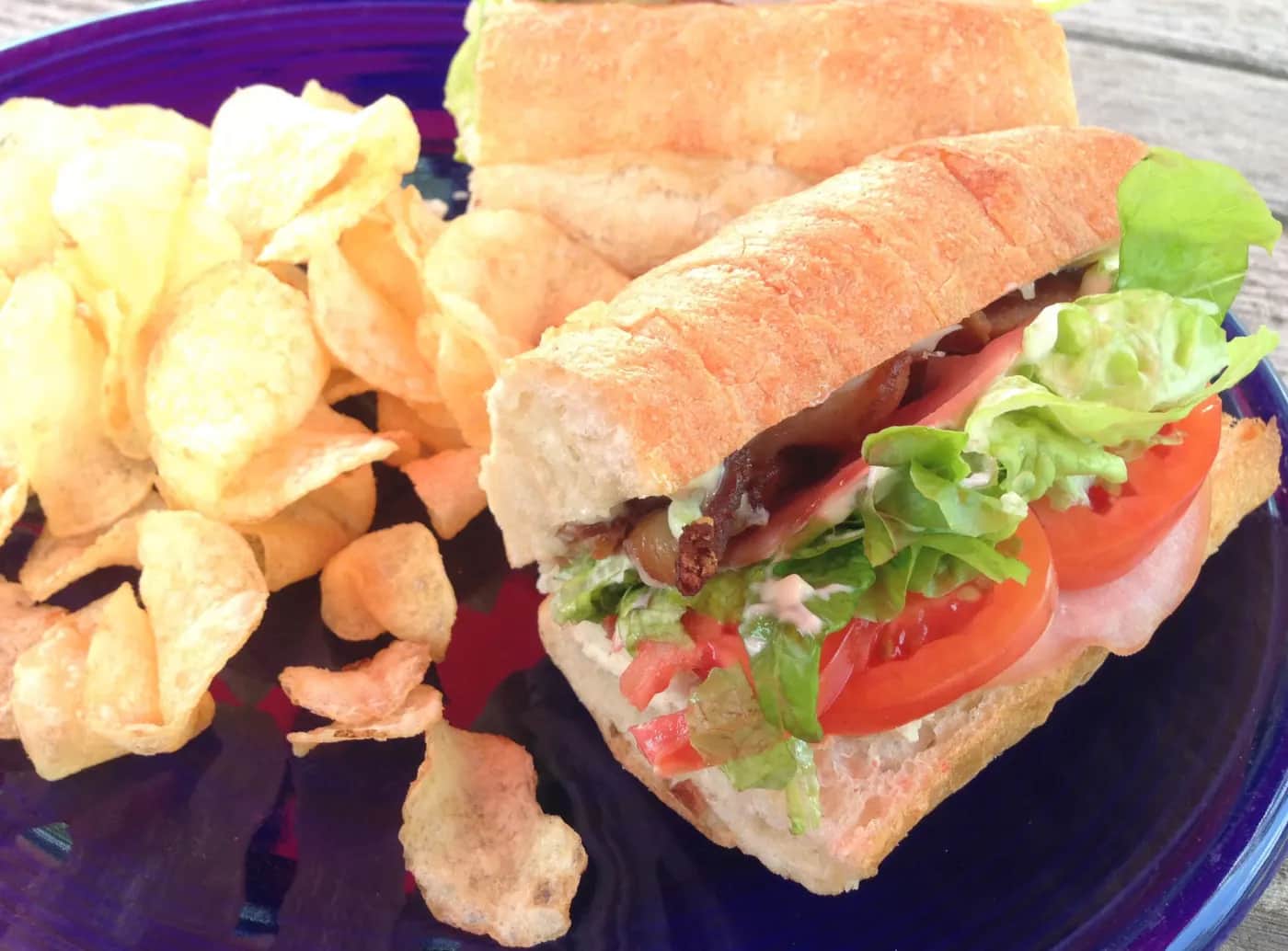 A fresh sandwich on local bread with a side of chips